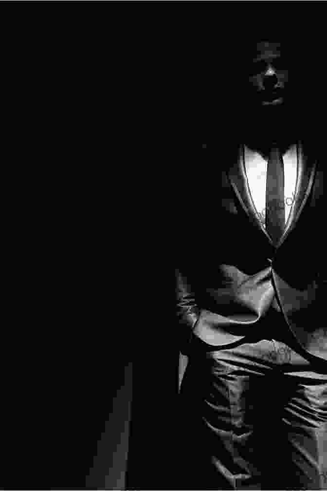 A Man In A Suit Standing In A Dark Room, His Face Obscured By Shadows. Agent Provocateur: The Dorset Boy 3